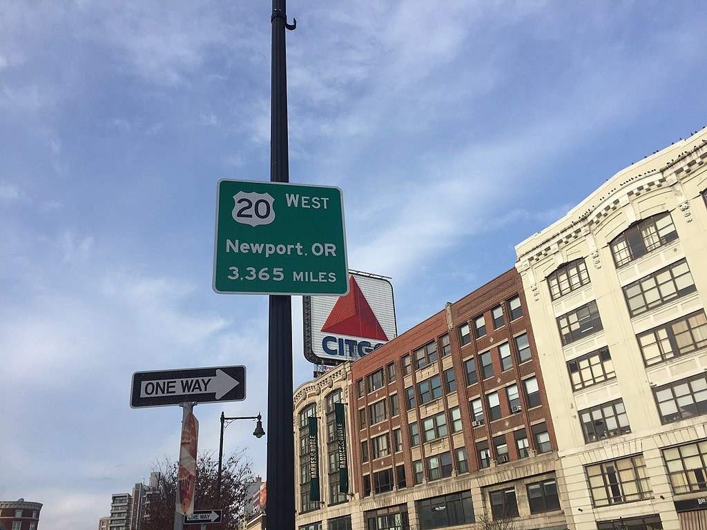 Sign at start of US highway 20 reading "[US 20 shield] West / Newport, OR / 3,365 miles"