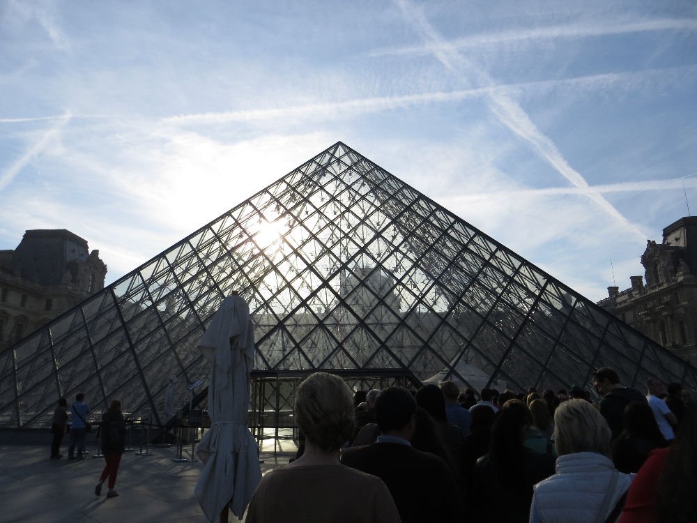 The pyramide entry into the Louvre with tourists waiting to enter